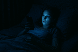 illuminated by blue light from a smartphone at night